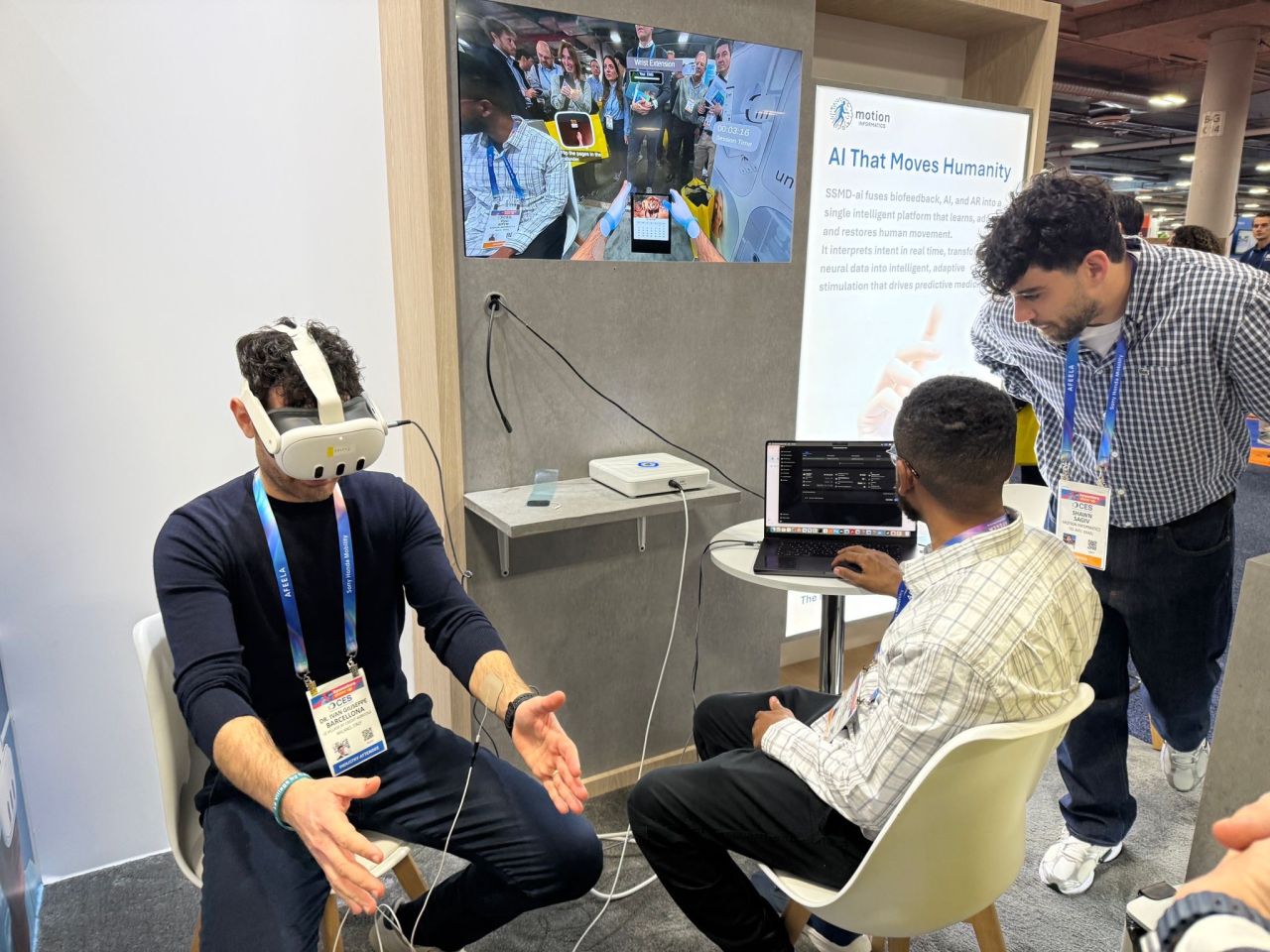 A connected AR and medical-device demonstration at CES with a Meta Quest headset and team members collaborating.